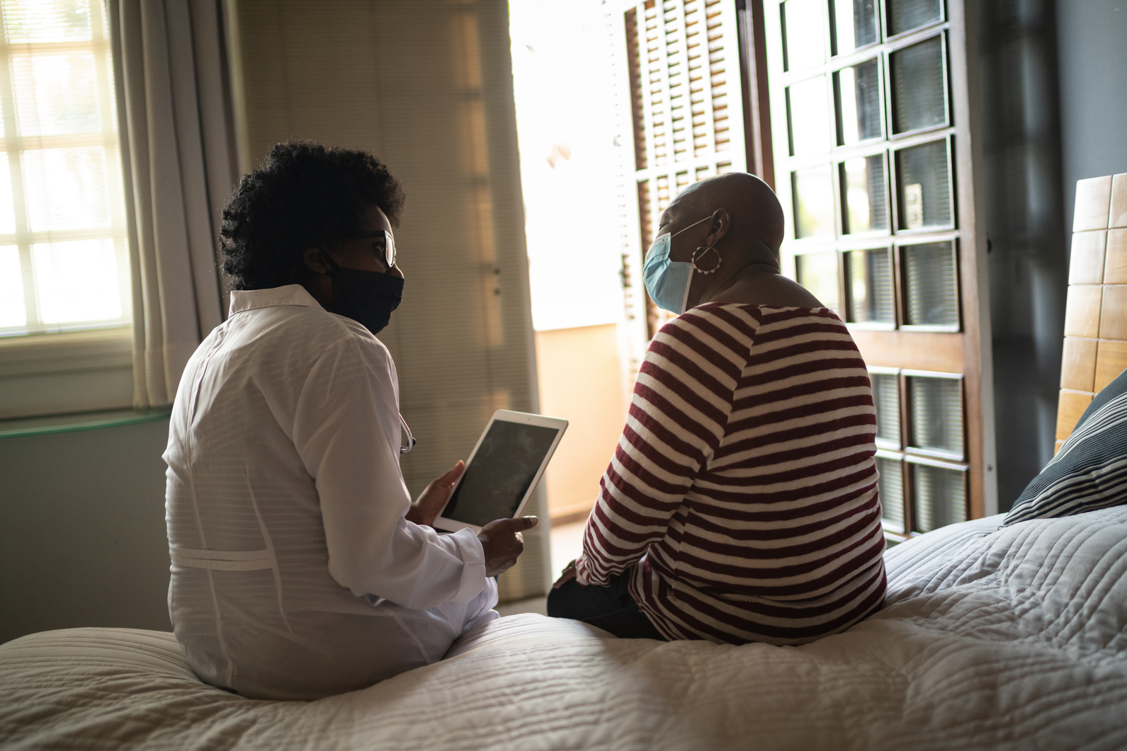 Health visitor and a senior woman during nursing home visit